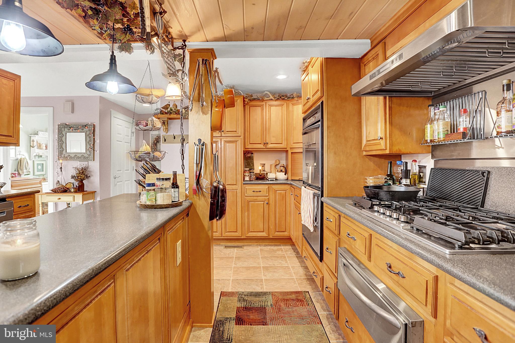 64 Metz Road Thompsontown, PA 17094 - Photo 19 of 59 a kitchen with stainless steel appliances granite countertop a stove and a refrigerator
