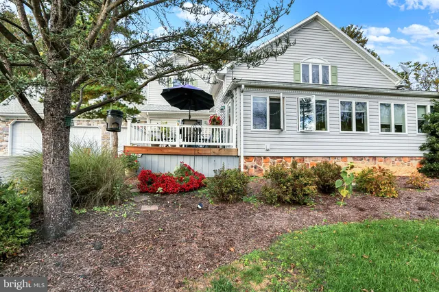 a front view of a house with a yard and potted plants