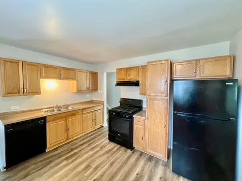 a kitchen with a refrigerator and a sink