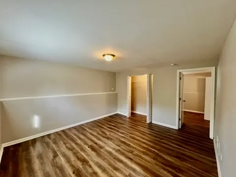 a view of an empty room and wooden floor