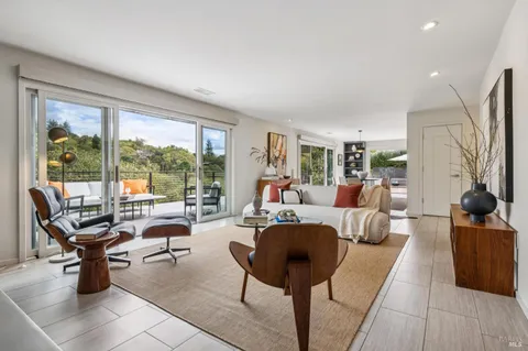 a view of a dining room with furniture and chandelier