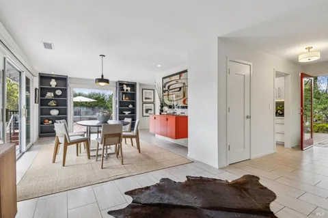 a bedroom with furniture and a large window
