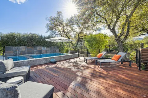 a view of a swimming pool with a patio and a yard