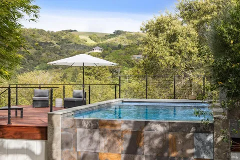 an aerial view of a house with swimming pool and garden