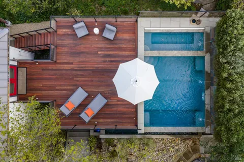 a view of a backyard with plants and a patio