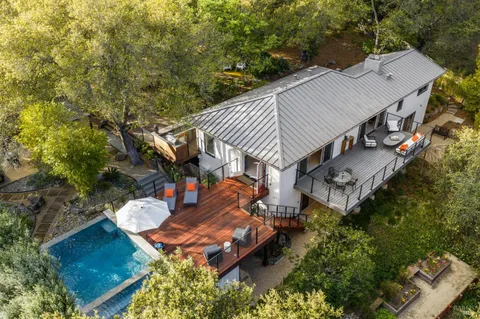 a living room with furniture large window and fire pit