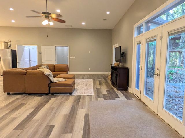 a view of a bedroom with furniture and window