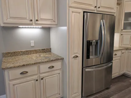 a view of a dining room with furniture a kitchen and chandelier