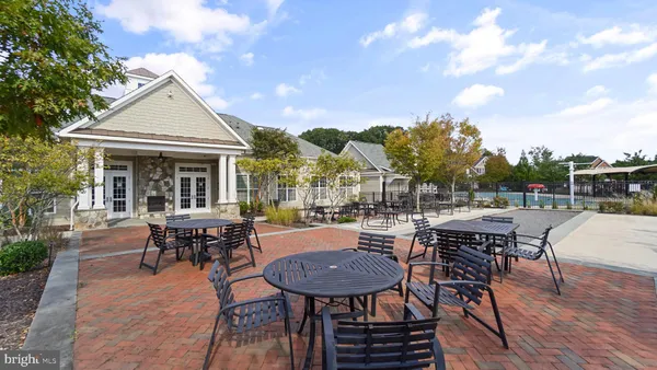 a view of a house with patio and a garden