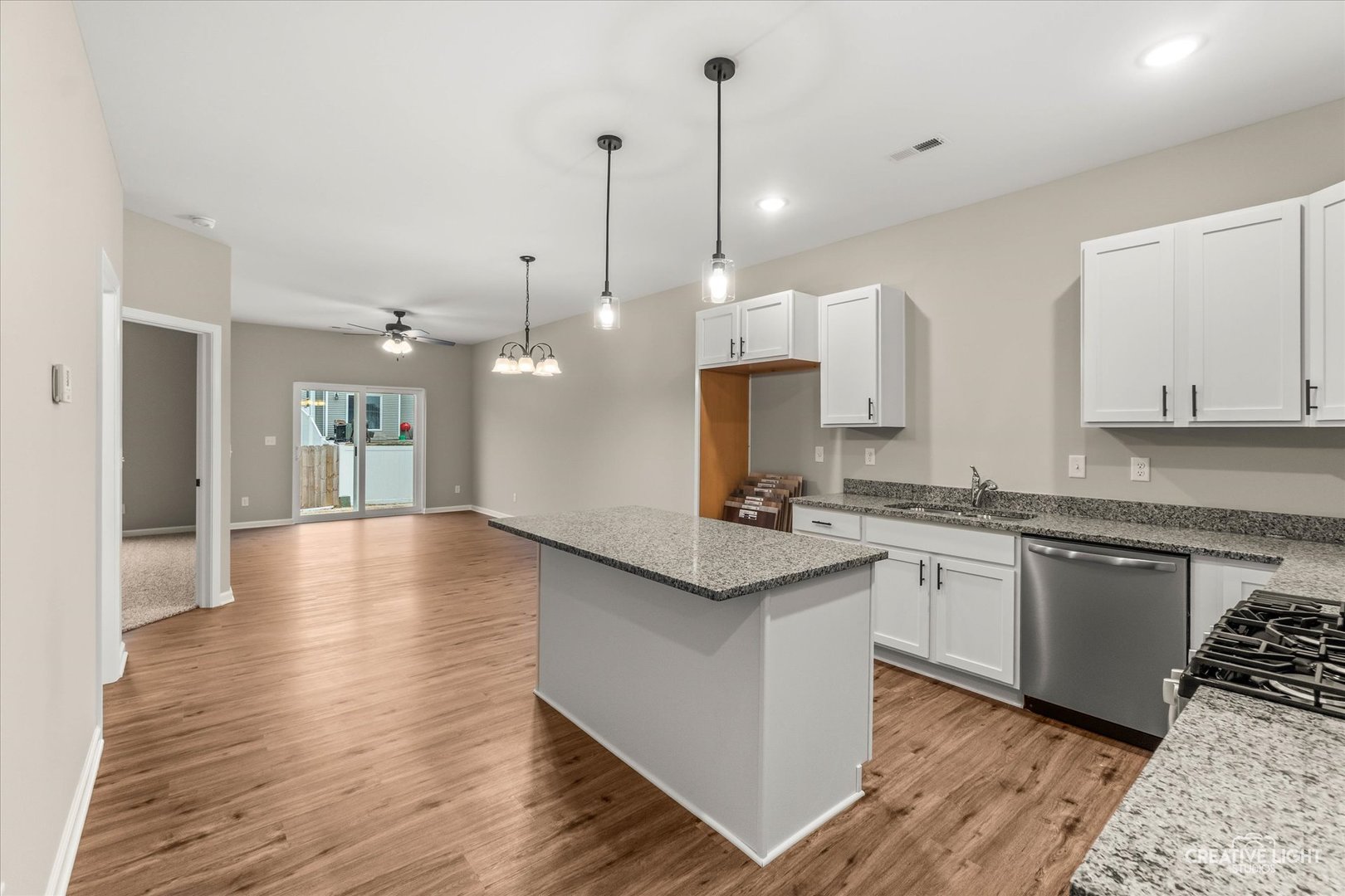520 Preston Street Cortland, IL 60112 - Photo 6 of 16 a kitchen with stainless steel appliances granite countertop a sink a stove a refrigerator and white cabinets with wooden floor