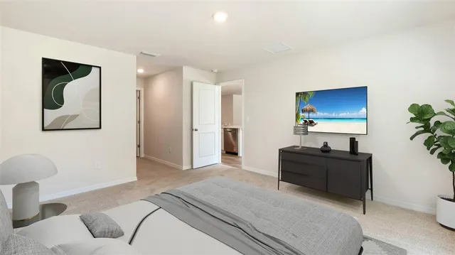 a bedroom with a bed and a potted plant