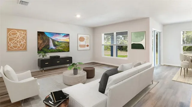 a living room with furniture and floor to ceiling windows