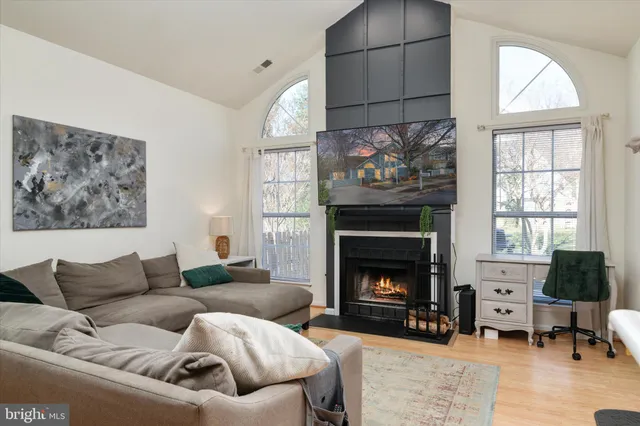 a living room with furniture a fireplace and a large window