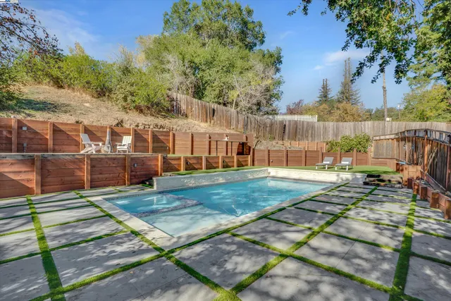 a view of a house with backyard and sitting area