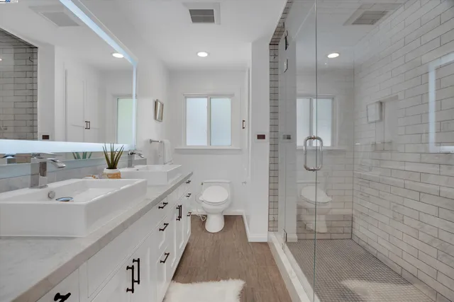 a spacious bathroom with a granite countertop sink a toilet and shower