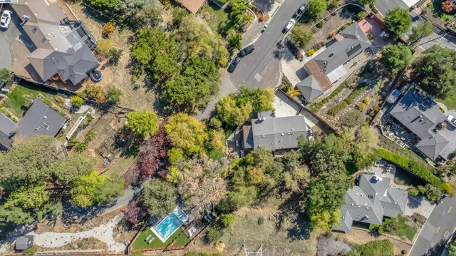an aerial view of a house with a yard and garden