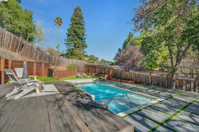 a view of backyard with wooden fence