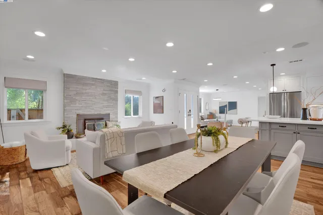 a living room with furniture a fireplace and a table