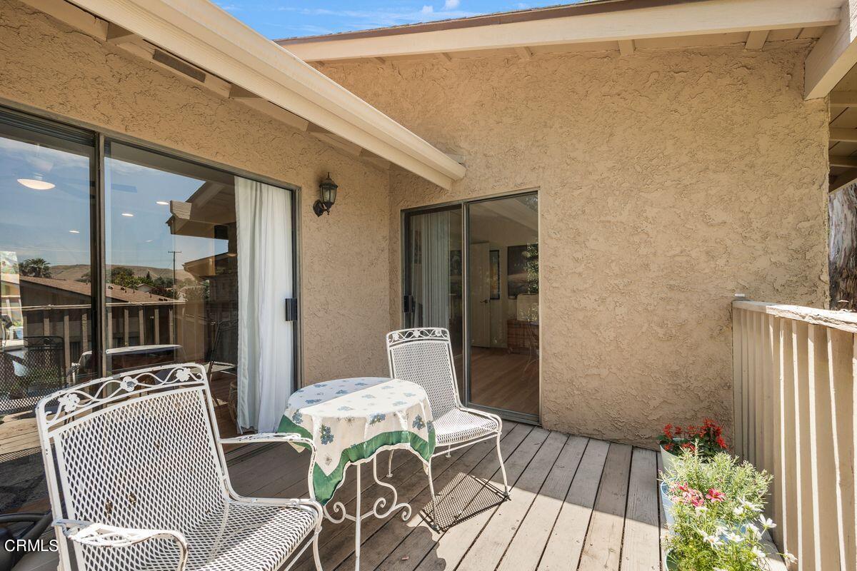 4448 Lubbock Drive, Unit D Simi Valley, CA 93063 - Photo 9 of 19 a balcony with wooden floor table and chairs