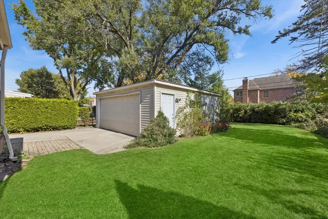 a view of backyard of house with green space