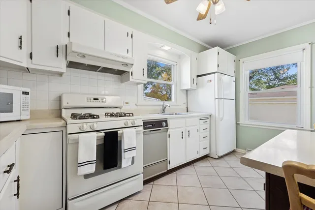 a kitchen with cabinets stainless steel appliances and a counter space