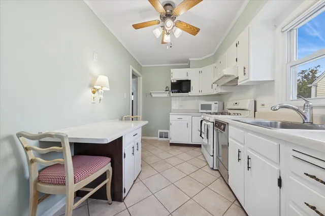 a kitchen with cabinets a sink and appliances