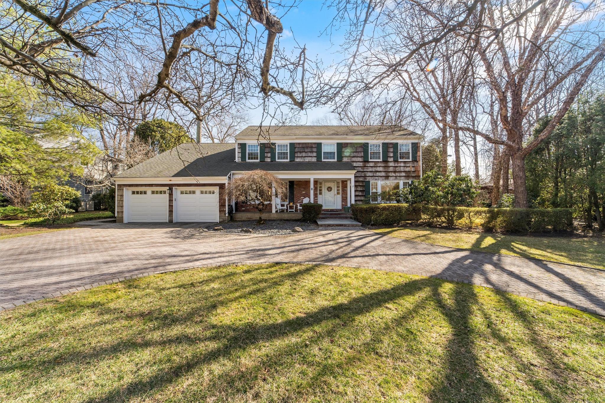 9 Pebble Beach Drive Purchase, NY 10577 - Photo 1 of 1 a front view of a house with a yard and trees