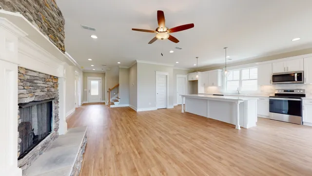 a view of kitchen with sink microwave and stove top oven