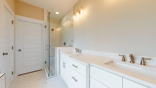 a bathroom with a toilet sink vanity and shower