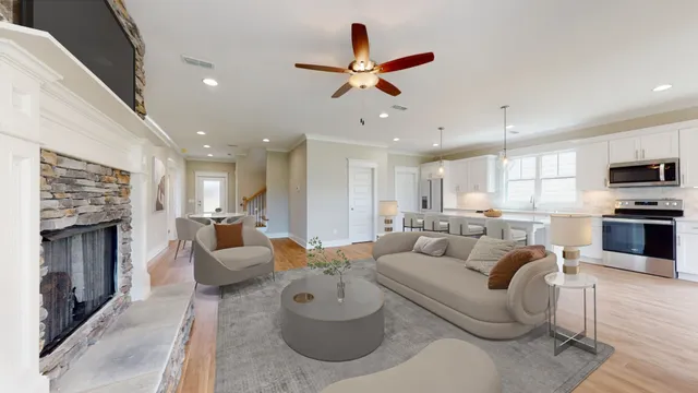 a living room with furniture kitchen view and a fireplace