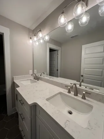 an aerial view of residential houses with outdoor space and lake view