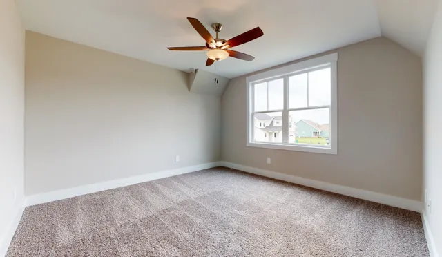 a view of a swimming pool with outdoor seating and a forest