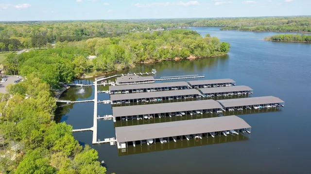 a front view of a house with yard and large trees