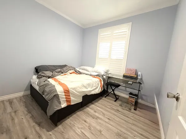 a bedroom with a bed a table and chair