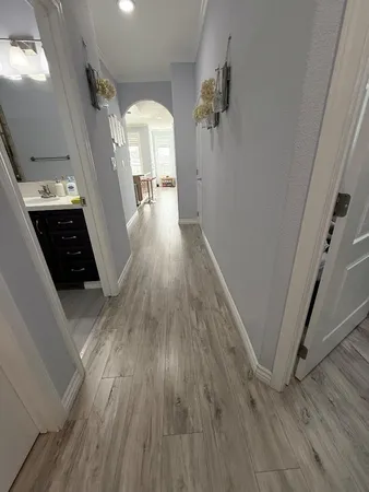 a view of a hallway view with wooden floor and staircase