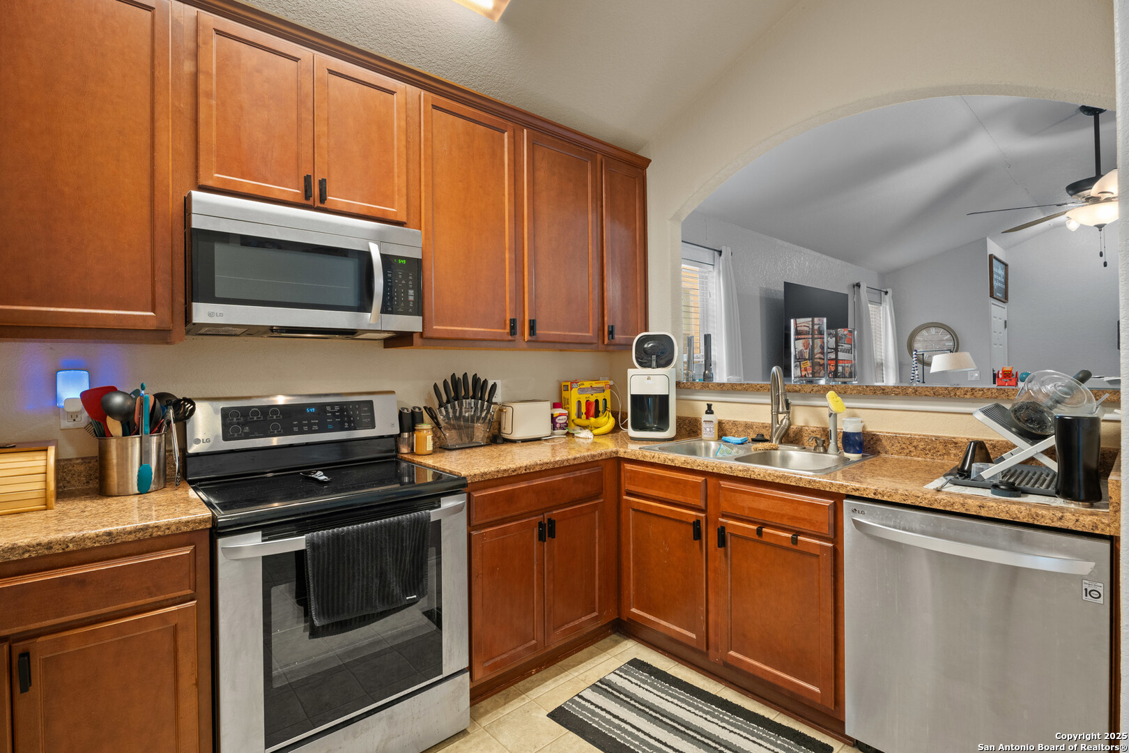 9419 Copper Mist Converse, TX 78109 - Photo 13 of 25 a kitchen with stainless steel appliances a stove sink microwave and cabinets