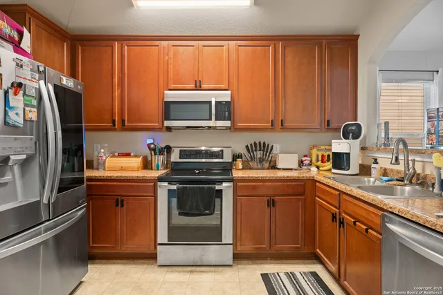 a kitchen with a sink stove and refrigerator