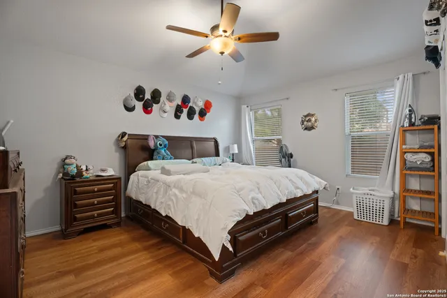 a bed room with a bed and a ceiling fan