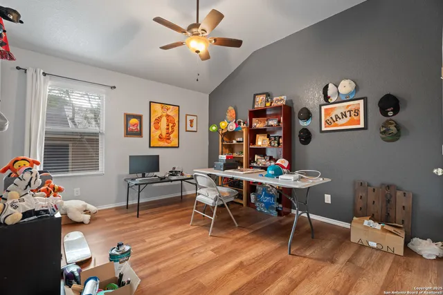 a view of a workspace with furniture window and wooden floor