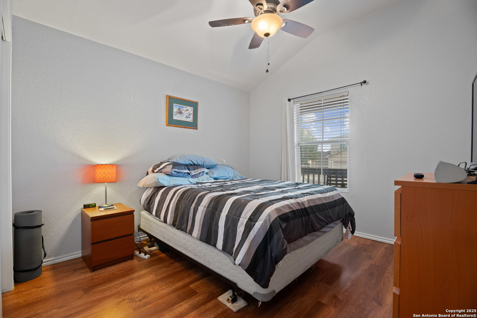 9419 Copper Mist Converse, TX 78109 - Photo 19 of 25 a bedroom with a bed and a chandelier