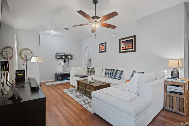 a living room with furniture and wooden floor