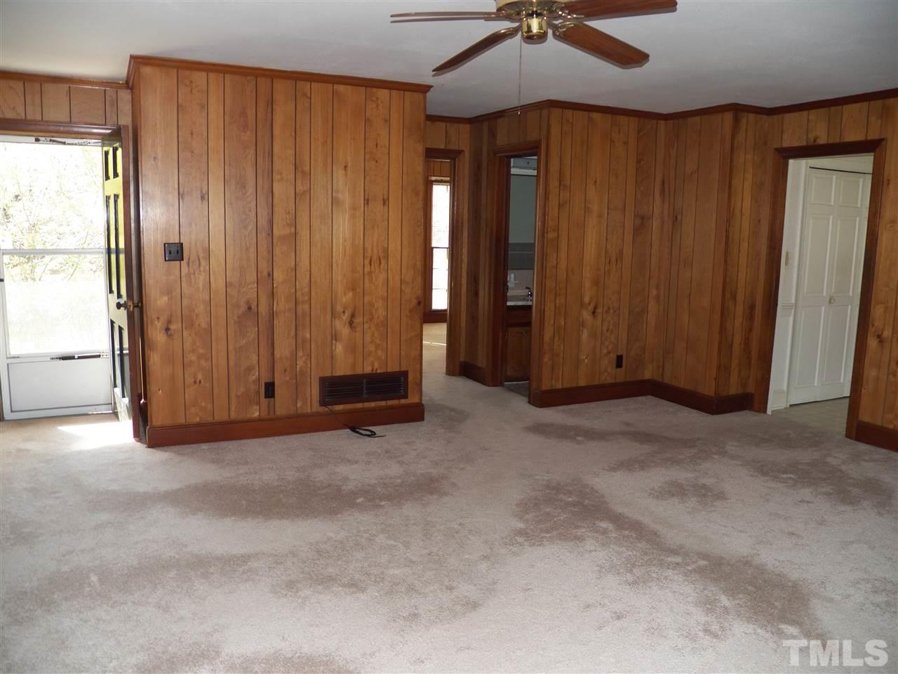 4704 Stiller Street Raleigh, NC 27609 - Photo 13 of 25 an empty room with a ceiling fan and entryway