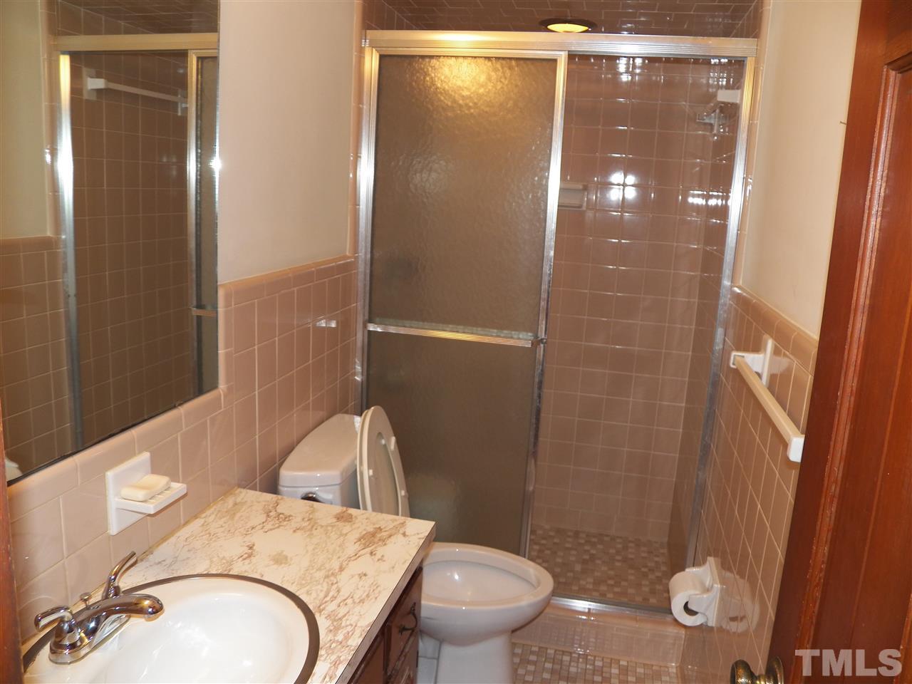 4704 Stiller Street Raleigh, NC 27609 - Photo 14 of 25 a bathroom with a granite countertop sink toilet and shower