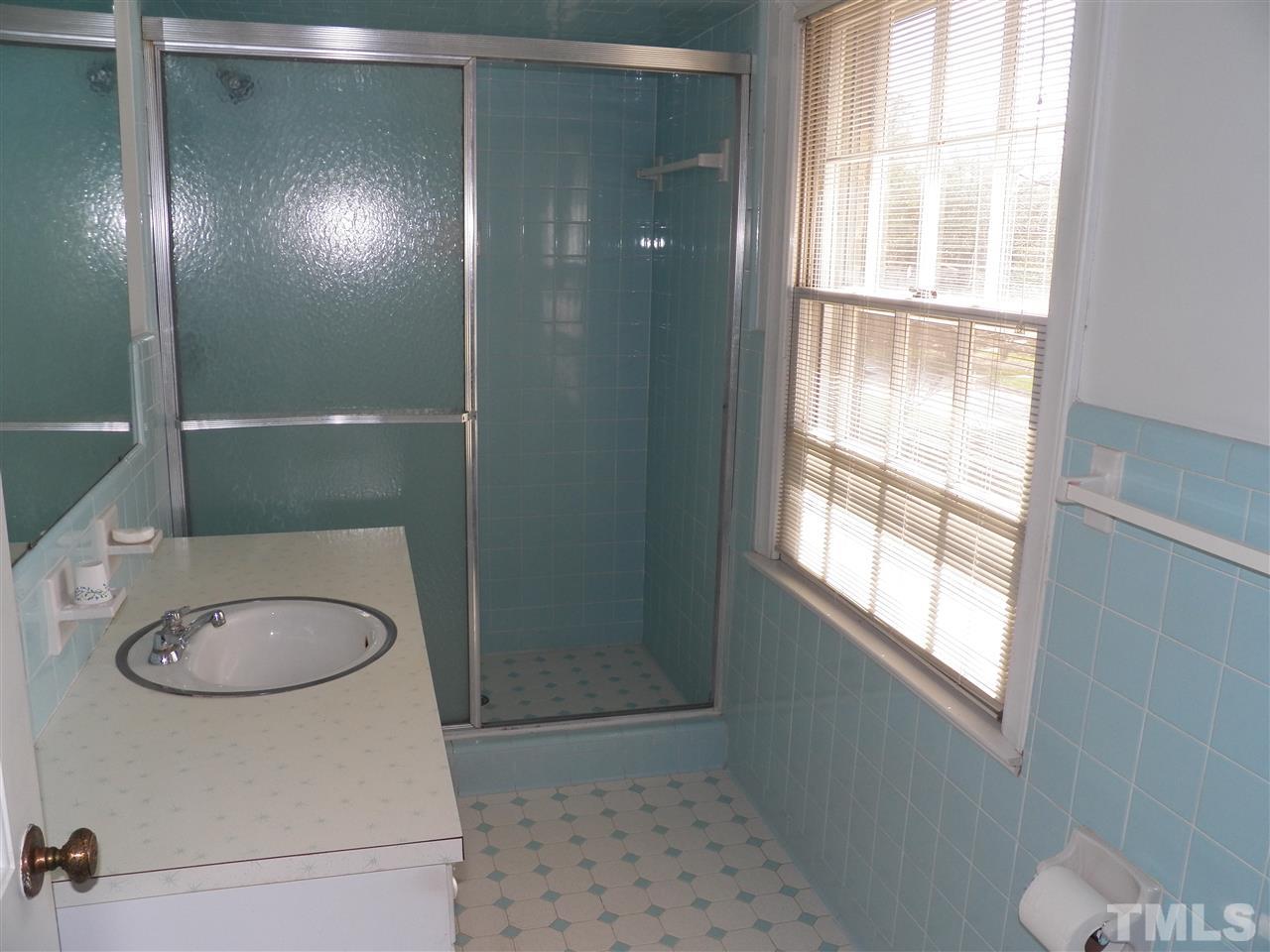 4704 Stiller Street Raleigh, NC 27609 - Photo 17 of 25 a bathroom with a granite countertop sink toilet and shower