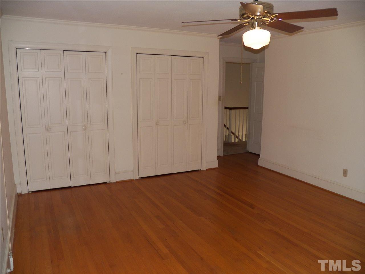 4704 Stiller Street Raleigh, NC 27609 - Photo 20 of 25 a view of an empty room with wooden floor