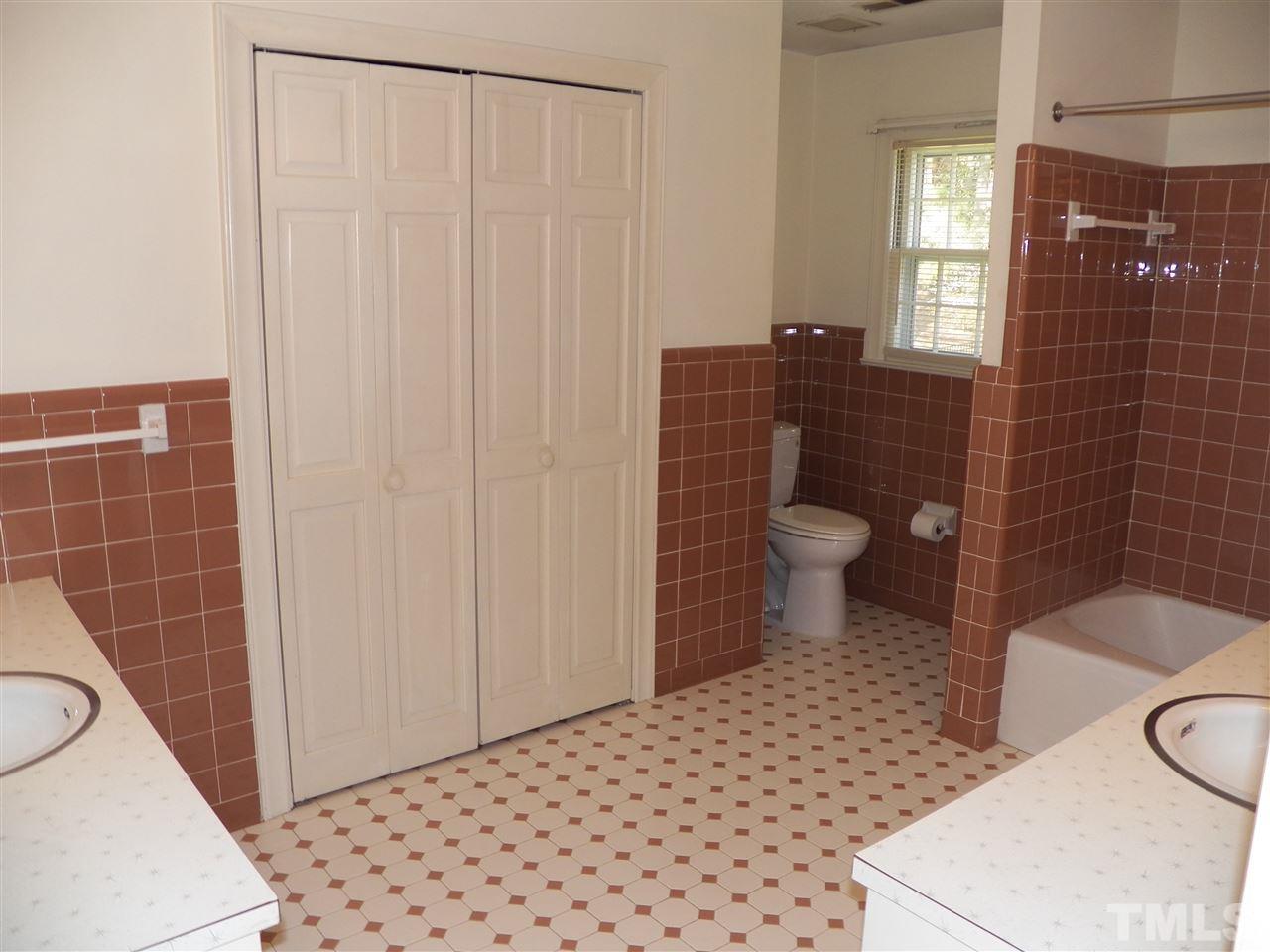 4704 Stiller Street Raleigh, NC 27609 - Photo 22 of 25 a bathroom with a toilet and a shower