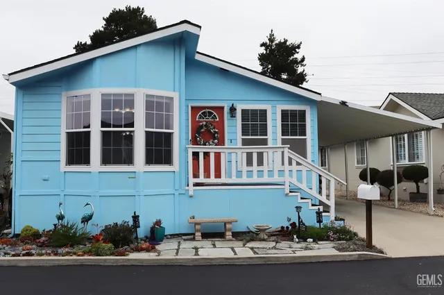 a front view of a house with a yard and glass windows