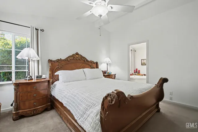 a bedroom with a bed and a large window