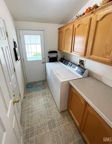 a bathroom with a granite countertop toilet sink and mirror