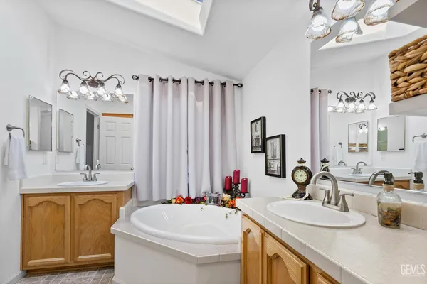 a bathroom with a sink double vanity and a mirror